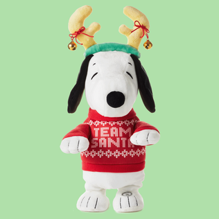 Snoopy plush wearing reindeer antlers and Team Santa' sweater